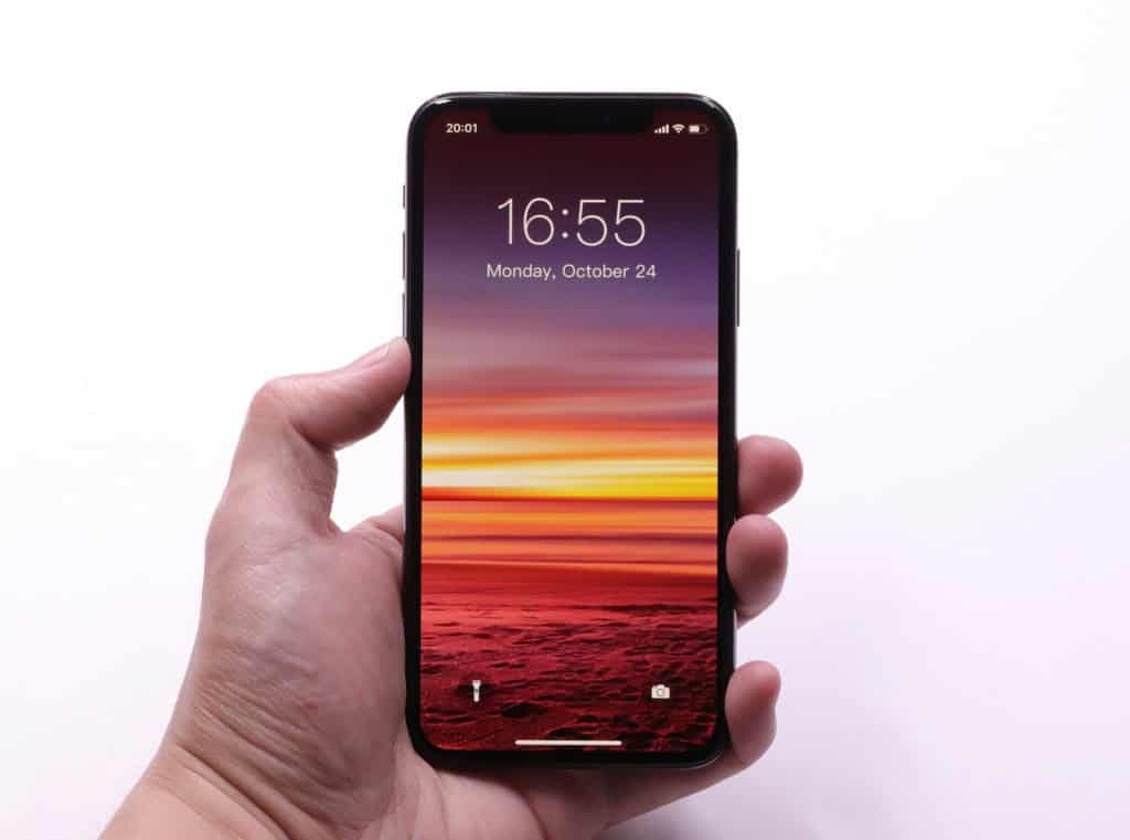 smartphone with sunset wallpaper